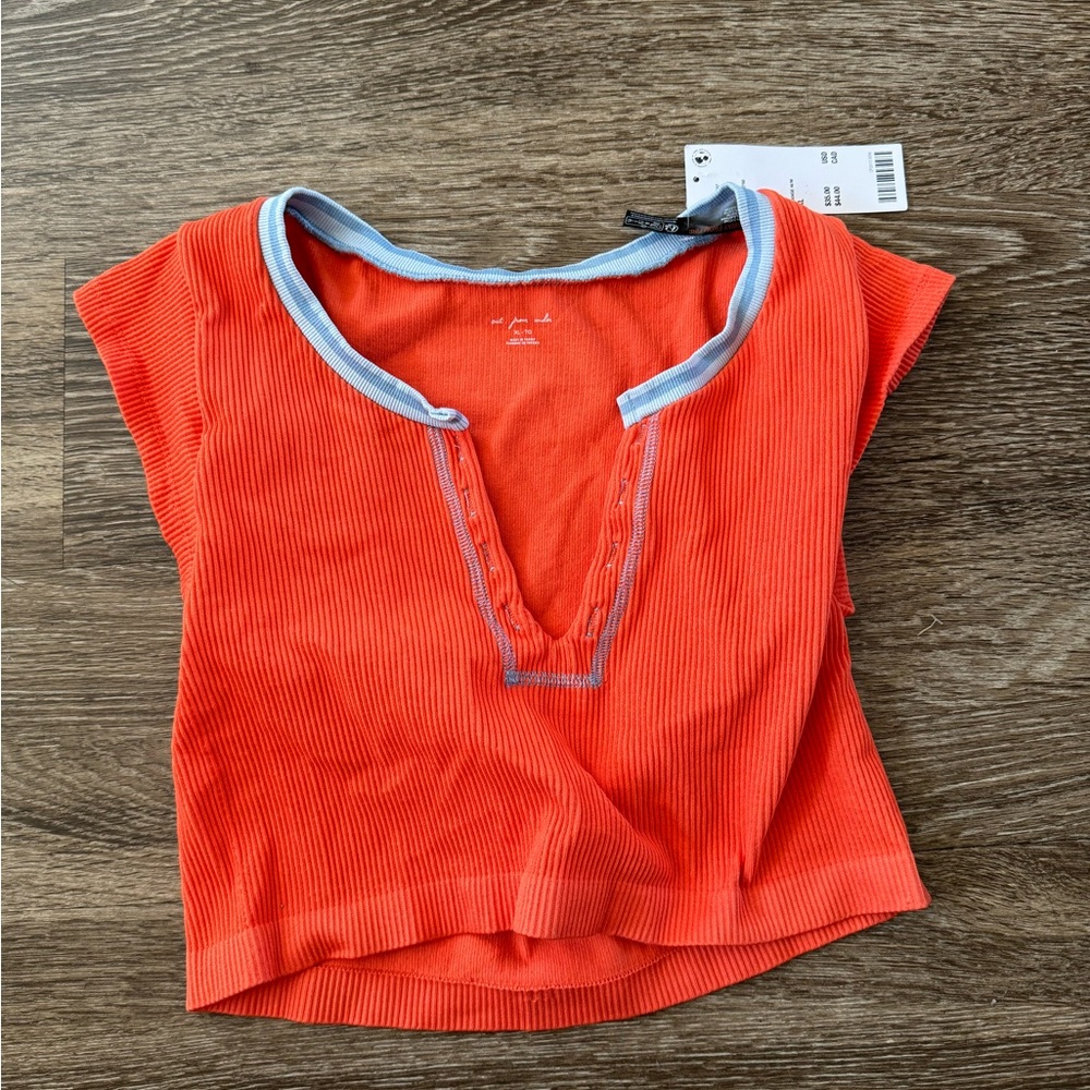 I am selling a orange and blue urban top!